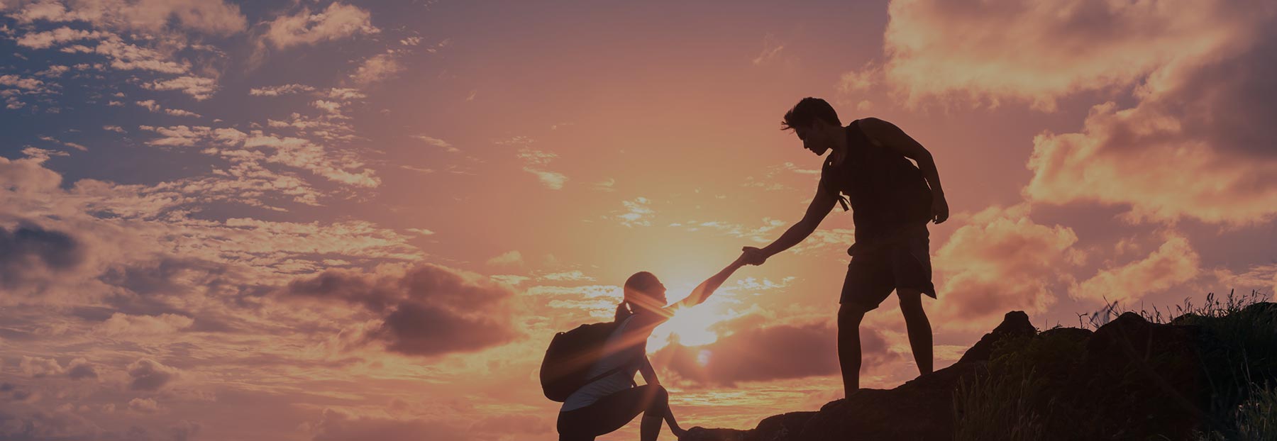 Hikers assisting each other during a hike
