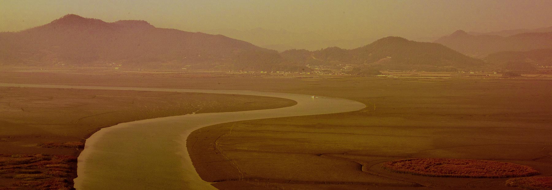 View of road curving into city and mountains