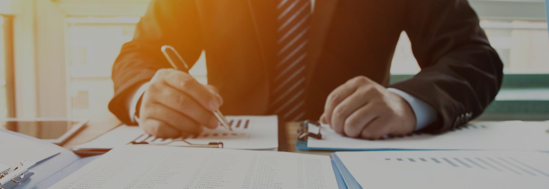 Close up of professional man writing at desk