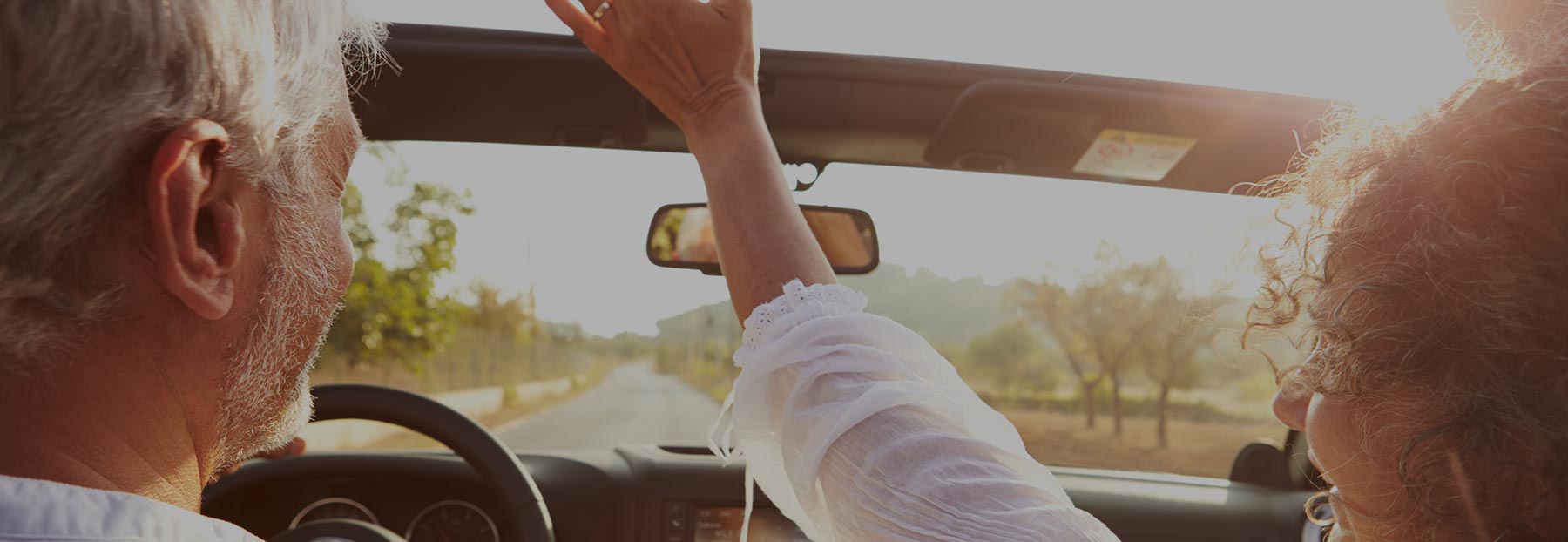 Close up of couple enjoying a ride in convertible car
