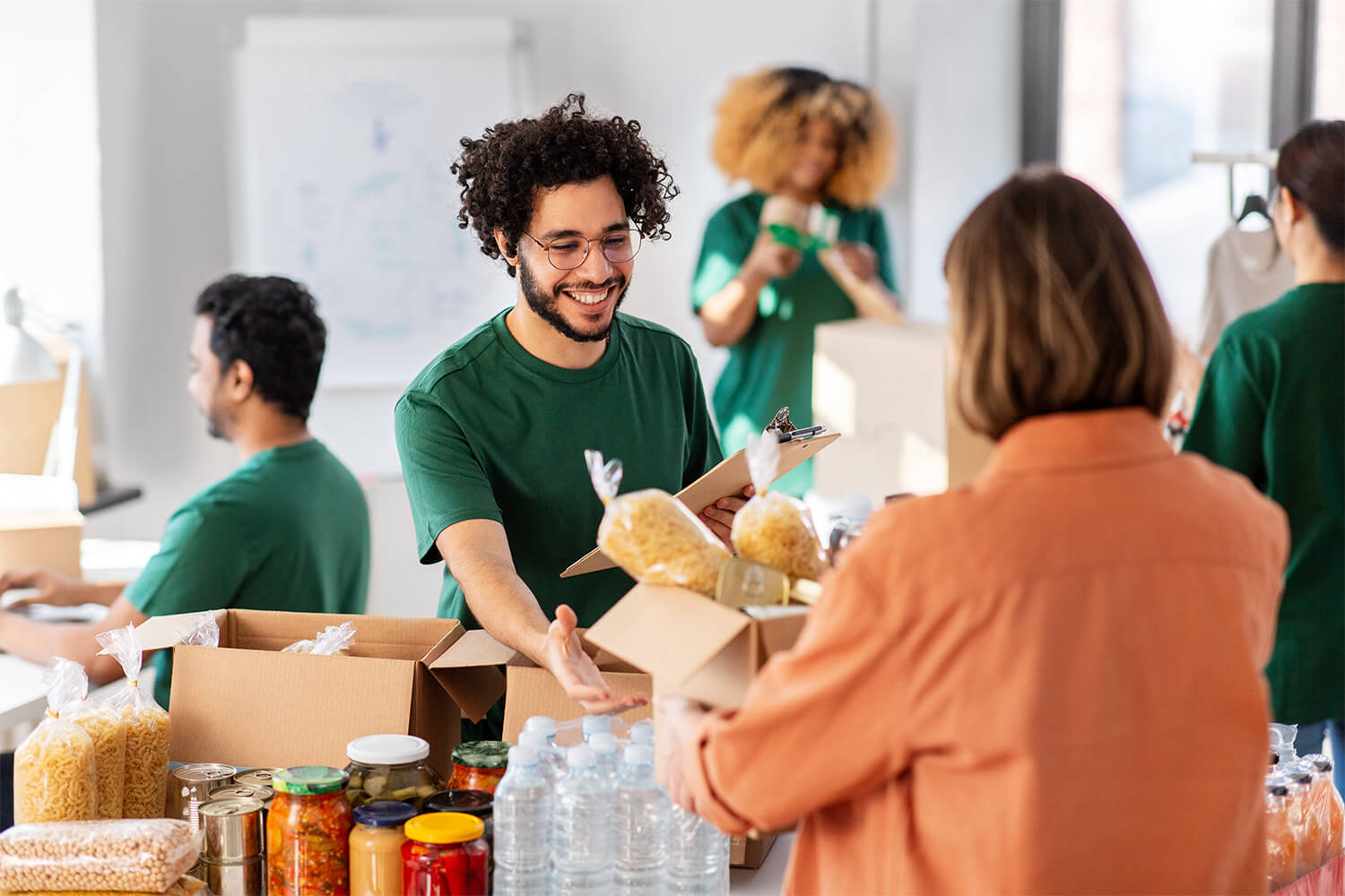 Volunteers packing food supplies for distribution at community center.
