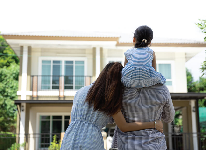 Family looking up at their home, hugging