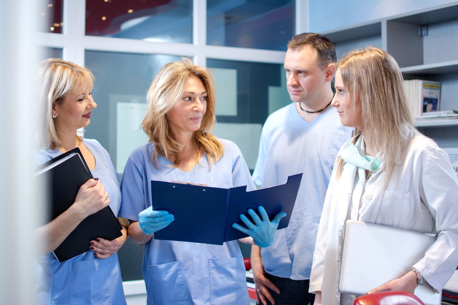 Dental owner leading conversation with her team
